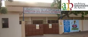 Façade d’un bâtiment avec des panneaux indiquant la direction des archives nationales et un logo des archives nationales du Bénin