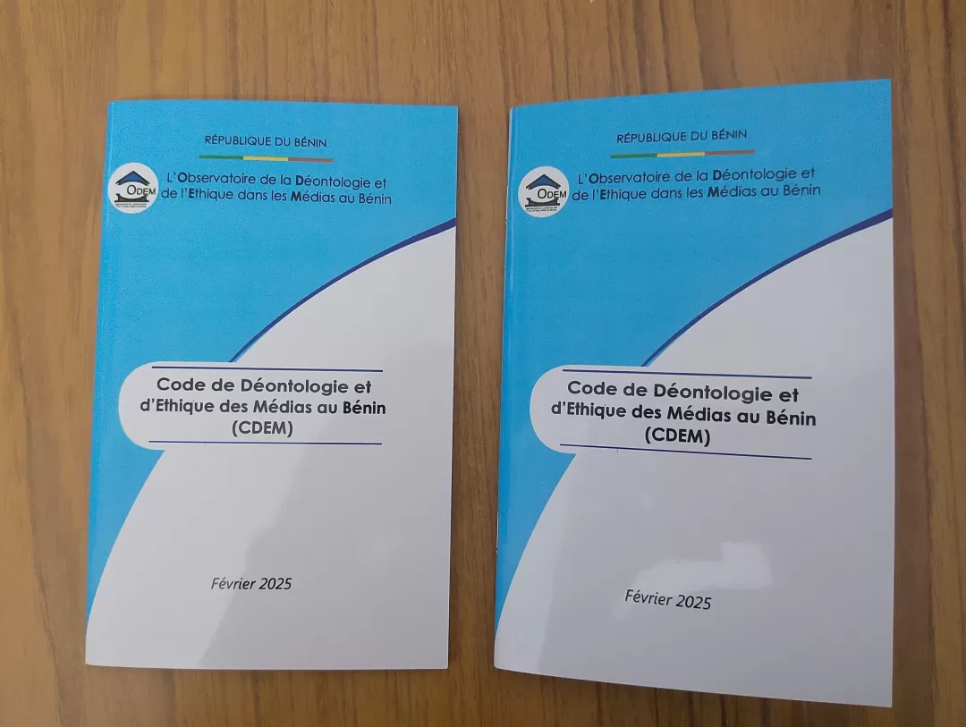 Deux exemplaires imprimés du Code de Déontologie et d’Éthique des Médias au Bénin posés sur une surface en bois