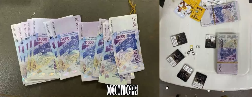 Billets en francs CFA éparpillés avec plusieurs cartes SIM et paquets de billets posés sur une surface blanche