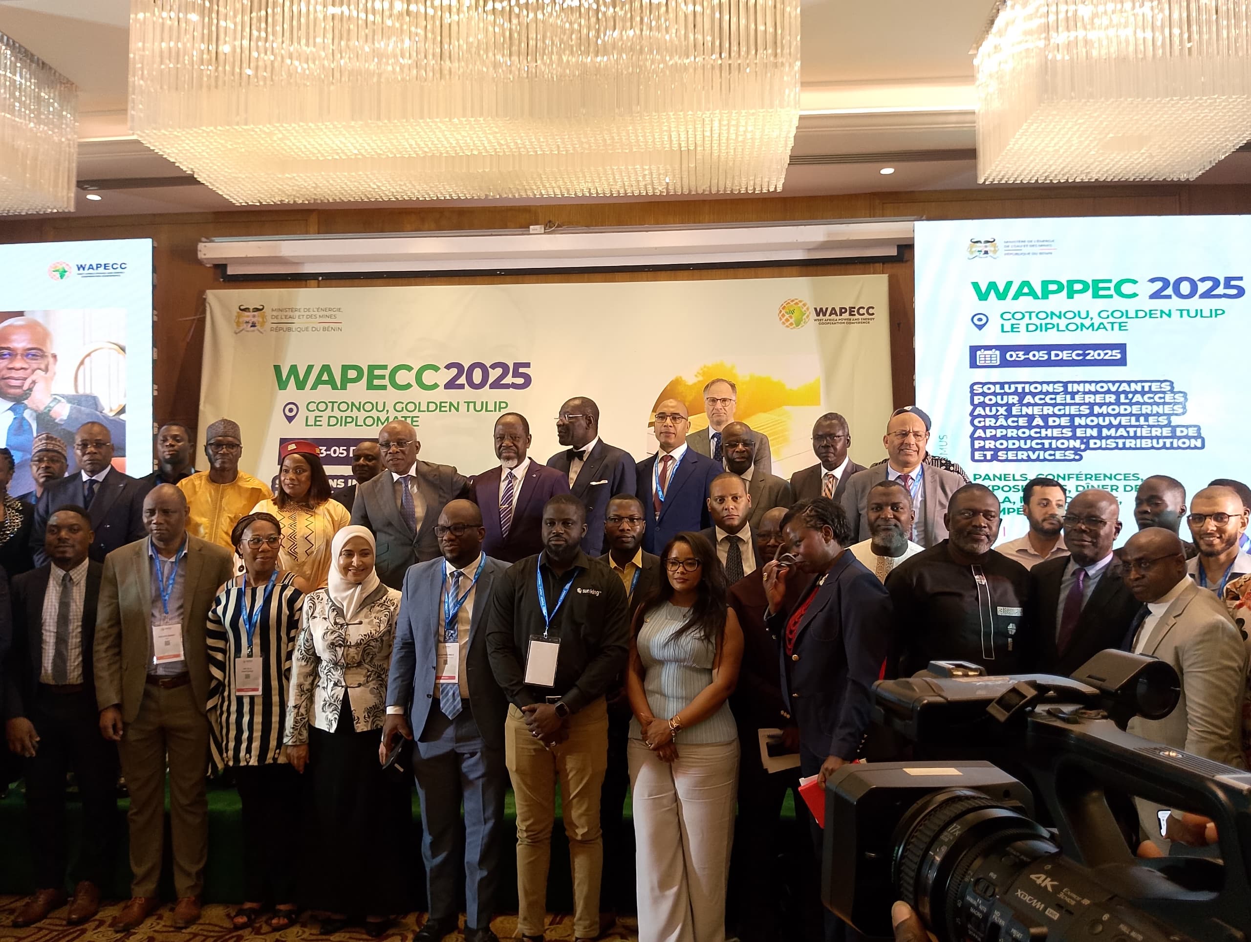 Grand groupe de personnes posant lors d'une conférence professionnelle avec panneaux WAPECC 2025 en arrière-plan